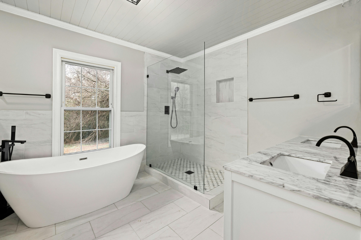 Aging in place bathroom remodel with curbless walk-in shower, grab bars, and non-slip flooring for senior safety
