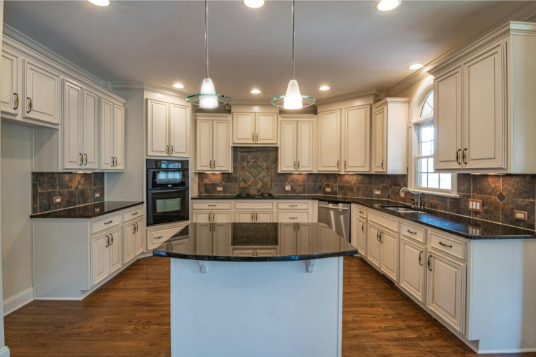 Affordable kitchen remodel with freshly painted white cabinets new peel and stick backsplash and updated hardware on a budget