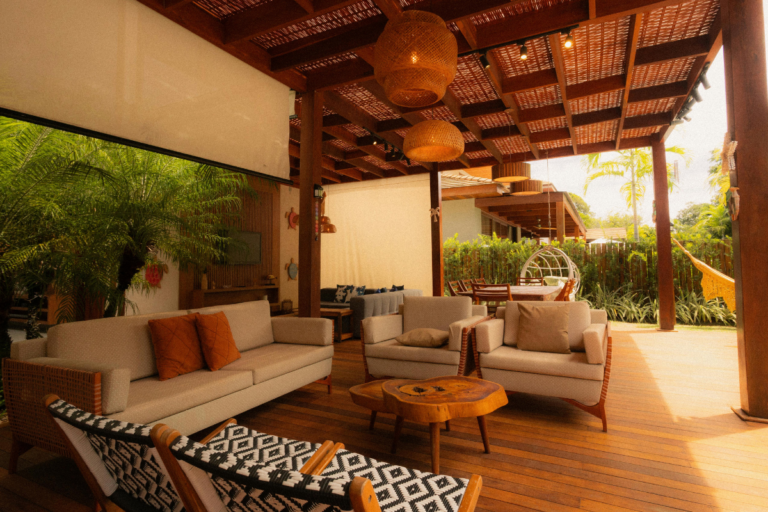 Bioclimatic pergola motorized louvers with adjustable aluminum slats open over a modern backyard patio with outdoor furniture