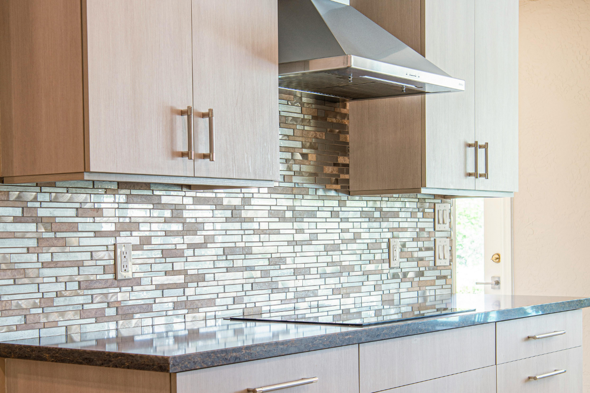 Peel and stick backsplash tile kitchen installation with marble hexagon pattern behind a modern countertop